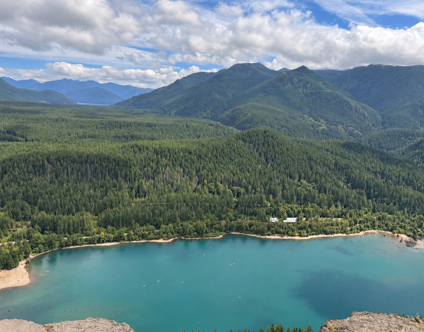 Ranya’s view of turquoise Rattlesnake Lake and forested mountains from the ledge