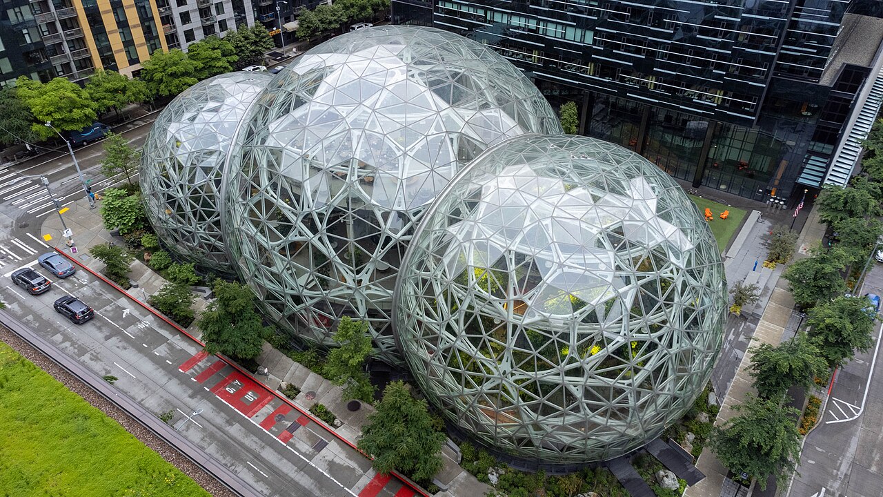 A wider daylight view of the Amazon Spheres and surrounding green landscaping