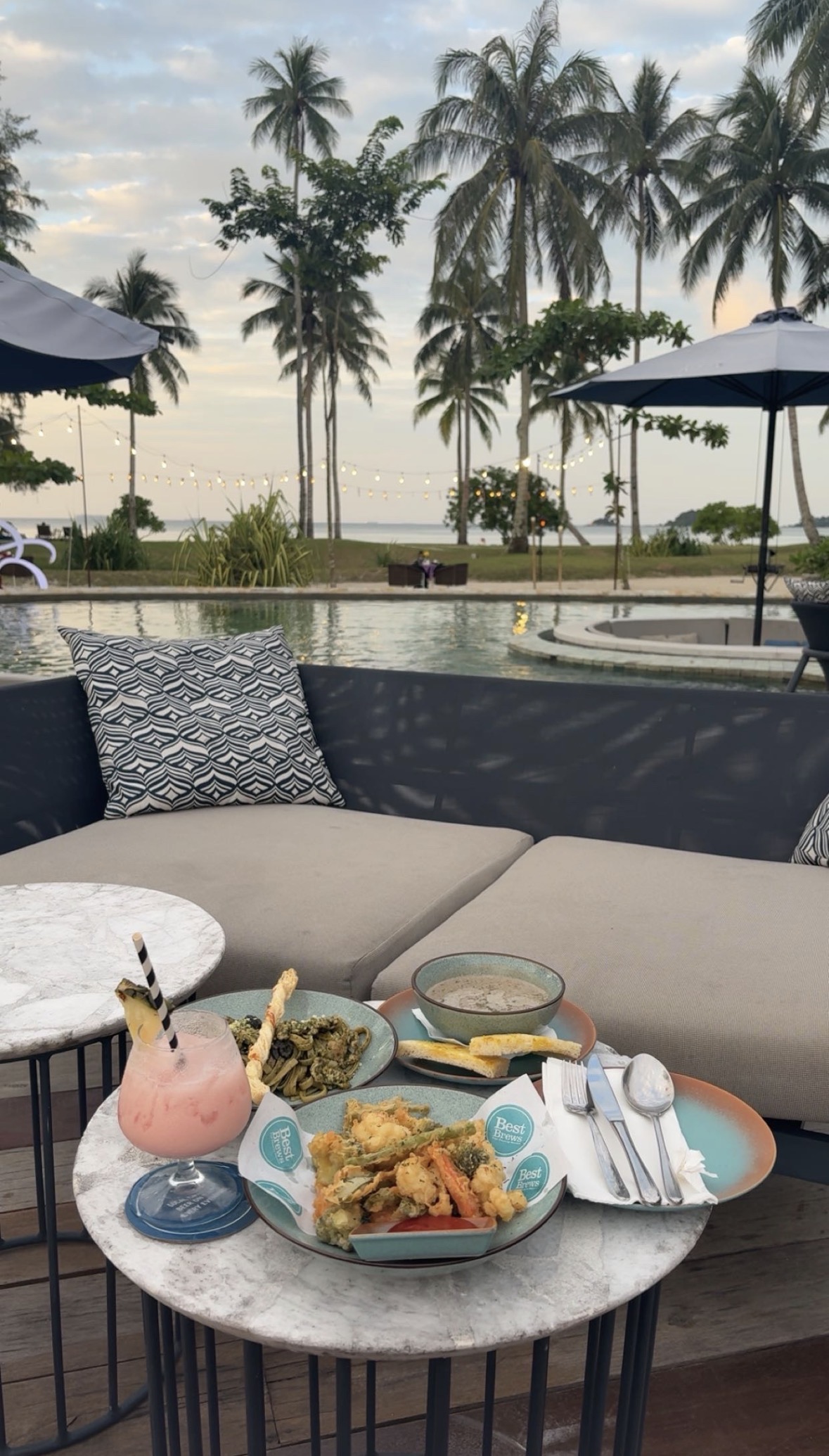 Dinner beside the resort pool at sunset