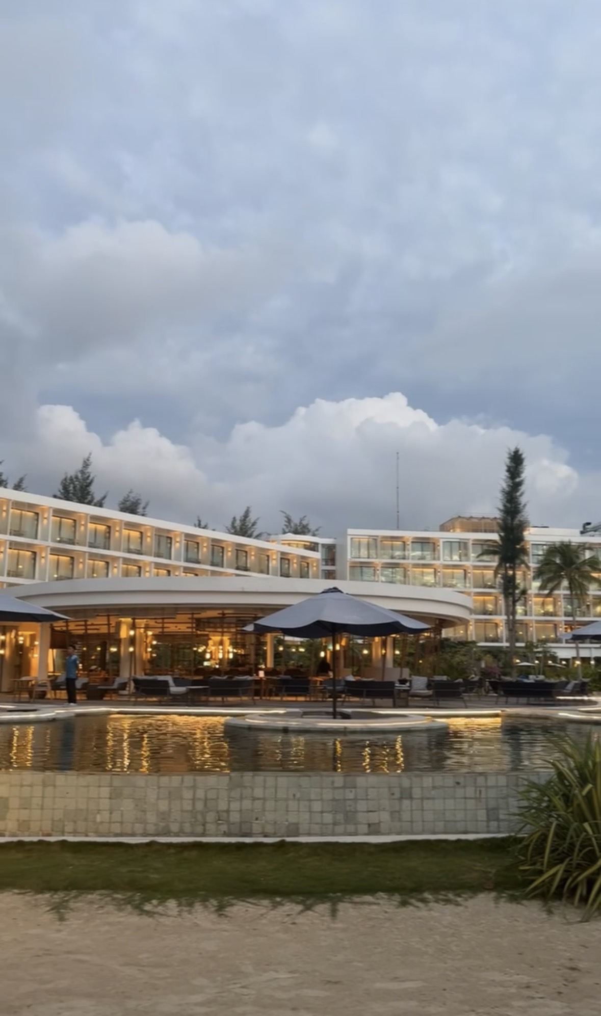Resort and pool glowing at dusk in Bintan