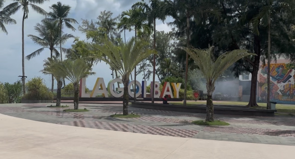 Lagoi Bay sign surrounded by palms