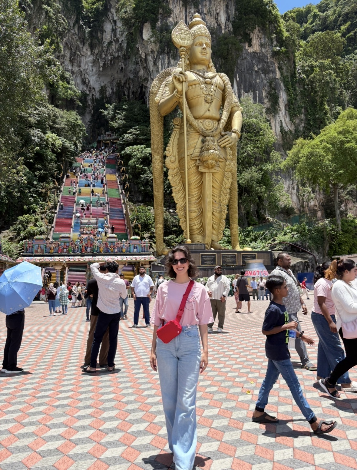 Ranya at Batu Caves beneath the golden Murugan statue